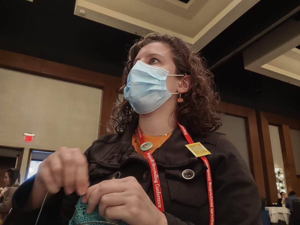 woman knitting in a conference room